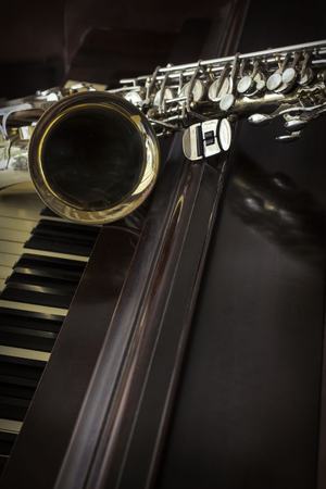 Old and worn Jazz saxophone and piano musical backgroundの写真素材