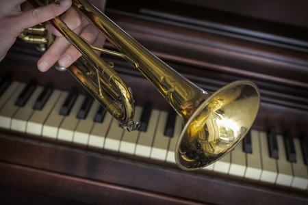 Old and worn Jazz trumpet and piano musical backgroundの写真素材