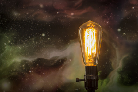 Decorative antique edison style filament light bulb with starscape backgroundの写真素材