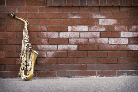 Jazz musical instrument saxophone with grungy street backgroundの写真素材