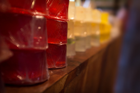 Rows of colorful homemade bar soap on wooden tableの写真素材