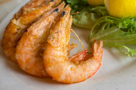 Fried whole heads on shrimp breaded and crispy with lettuce and lemonの写真素材