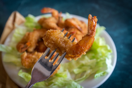 Large serving of popcorn shrimp tempura appetizer on bed of lettuceの写真素材