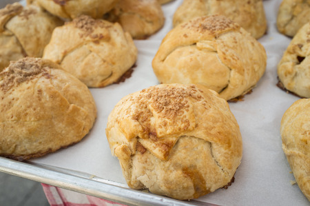 Closeup pile of fresh Irish cinnamon scones on wax paper