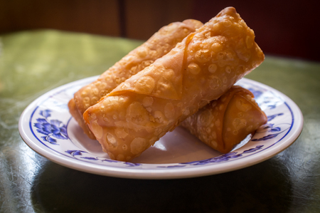 Chinese fried crispy egg rolls on fancy dinner plate