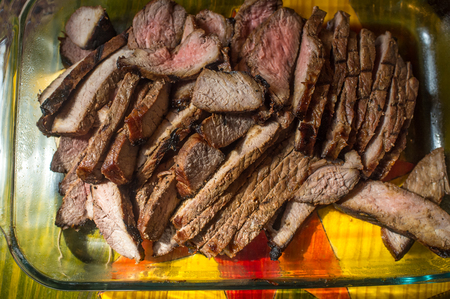 Sliced juicy medium rare skirt steak is serving trayの写真素材