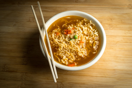 Spicy asian ramen noodle soup with chopsticks
