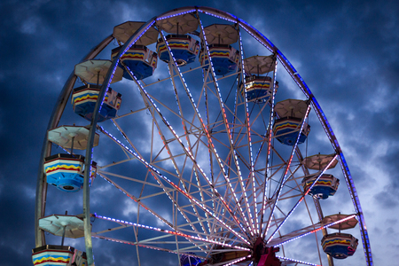 Close up summer carnival ferris wheel against blue skyの写真素材