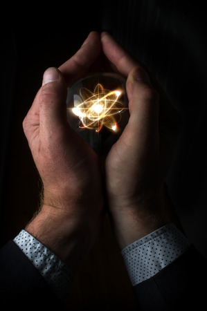 Holding atom in fortune teller magic crystal ballの写真素材