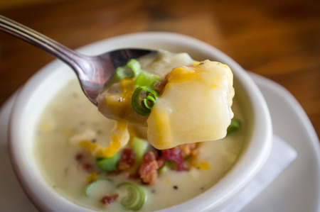 Creamy loaded baked potato soup with scallionの写真素材