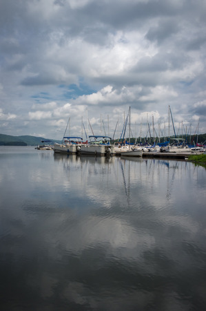 Summer lake marina with many docked sail boatsの写真素材