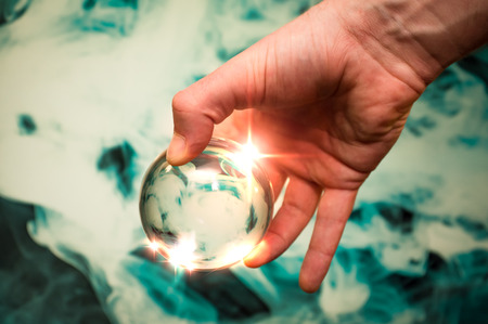 Holding the universe in fortune teller magic crystal ball