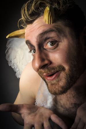 Fallen angel satan with feathered wings and moody lightingの写真素材