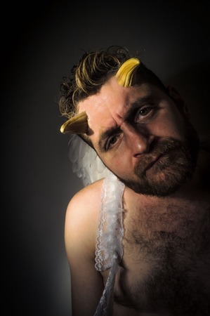 Fallen angel satan with feathered wings and moody lightingの写真素材