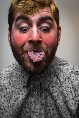 Sick feverish man with mouth covered in bacteria and virusesの写真素材