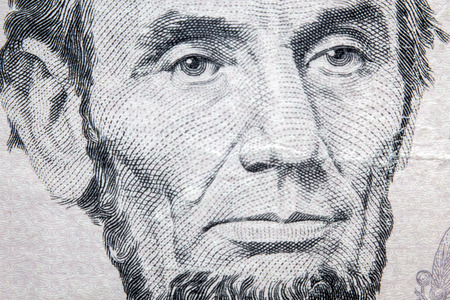 Macro closeup Abraham Lincoln on five dollar bill