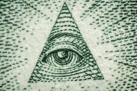 Macro closeup eye pyramid on back of dollar billの写真素材