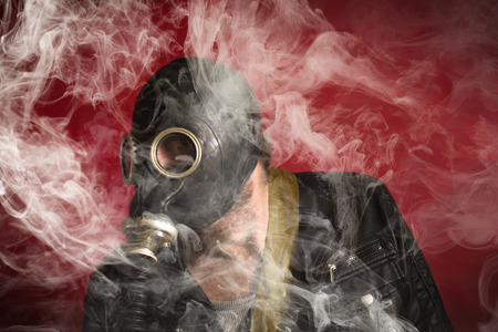 Scary man wearing authentic Russian gas mask with breathing hoseの写真素材