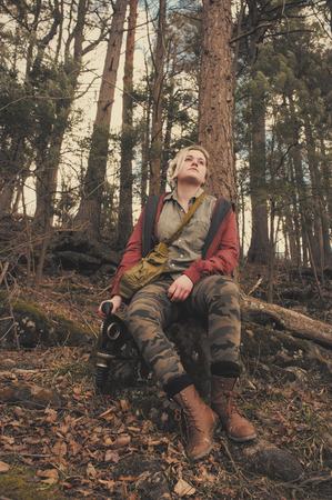 Pretty girl holding authentic Russian gas mask with breathing hoseの写真素材