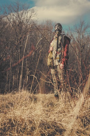 Scary girl wearing authentic Russian gas mask with breathing hoseの写真素材