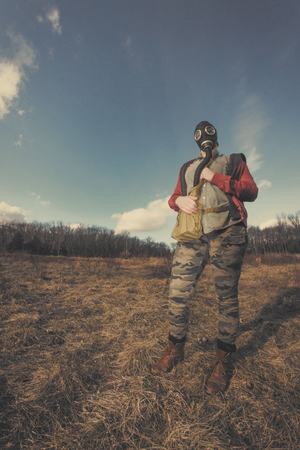 Scary girl wearing authentic Russian gas mask with breathing hoseの写真素材