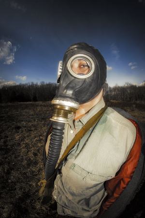 Scary girl wearing authentic Russian gas mask with breathing hoseの写真素材