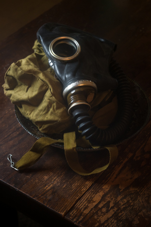 Authentic Soviet gasmask on rustic worn wooden tableの写真素材