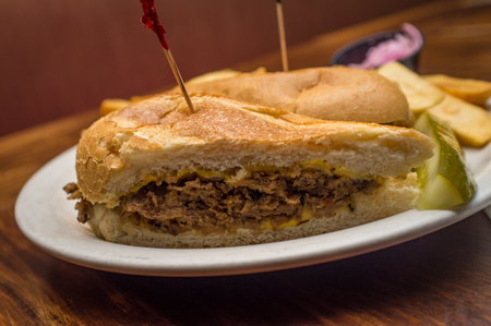 Cheesesteak with steak fries balsamic vinegar cole slaw and pickleの写真素材