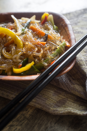 Korean Japchae vegetarian stir fried cellophane noodles with vegetablesの写真素材