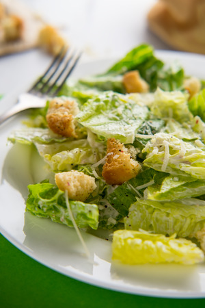 Fresh organic Caesar salad with ciabatta croutons and parmesan cheeseの写真素材