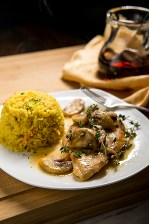 Healthy baked Italian chicken marsala with herbed yellow rice and mushroomsの写真素材