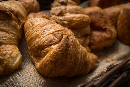 Fresh rustic home made croissants on hemp clothの写真素材