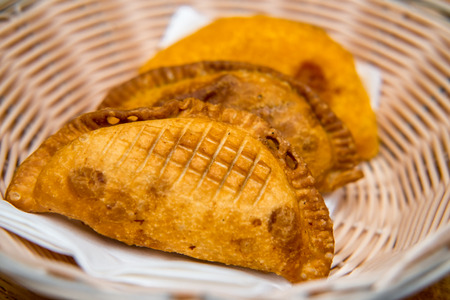 Basket of fresh crispy Mexican empanada meat pies