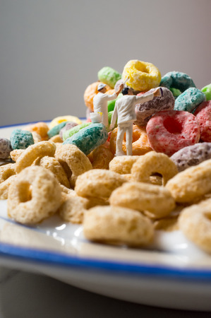 Tiny painting crew paints the oat loop cereal rainbow of colors