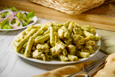 Creamy Italian pesto penne pasta with grilled chickenの写真素材