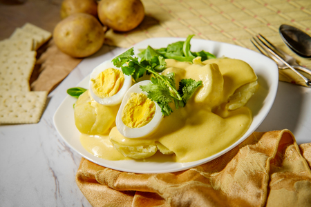 Papa a la Huancaina Peruvian potatoes and hard boiled eggs with spicy aji amarillo yellow sauceの写真素材