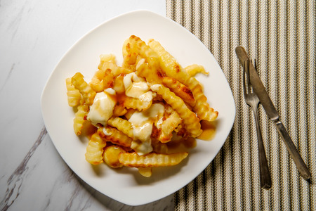 Canadian Poutine crinkle-cut fries with gravy and cheese curdの写真素材