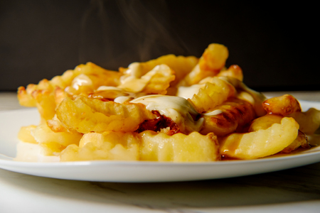 Canadian Poutine crinkle-cut fries with gravy and cheese curd
