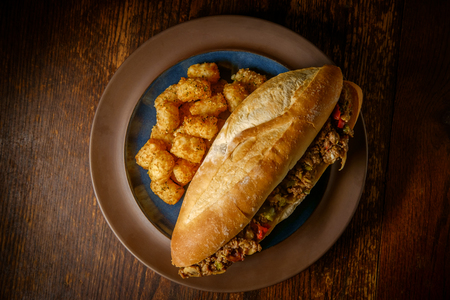 Philly Cheesesteak with diced onions peppers and mushrooms with tater-totsの写真素材