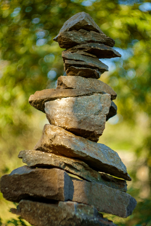 Peacful zen stack of balancing symbolic stones in woods