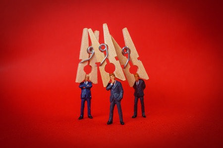 Businessman with clothespin on head symbolizing ignorance and refusal to listenの写真素材