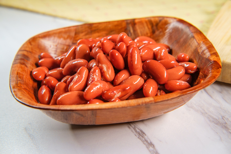 Chili ingredients wooden bowl kidney beans on marble counterの写真素材