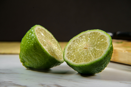 Sliced green lime on kitchen marble counter topの写真素材