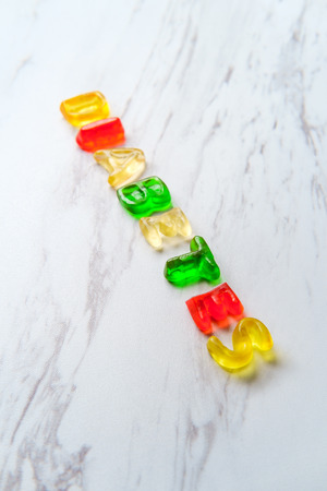Assorted colorful gummy candy letters spell the word Diabetes