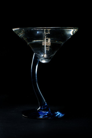 Jazz club concept with trumpet in martini cocktail glassの写真素材