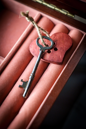 Key to my heart concept with antique skeleton key and rustic wooden heartの写真素材