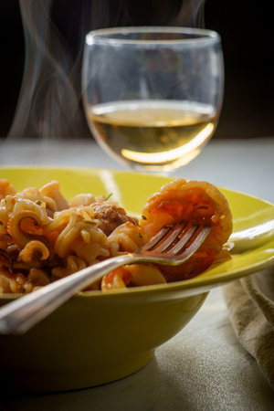 Italian radiatori pasta with shrimp and calamari in sweet sherry wine pink sauceの写真素材