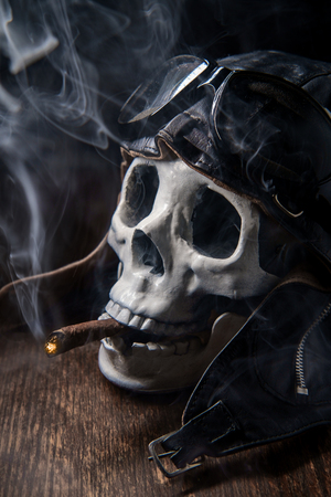 Spooky dead aviator skull puffing a fat cigarの写真素材