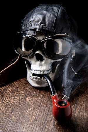 Spooky dead aviator skull puffing on tobacco pipeの写真素材