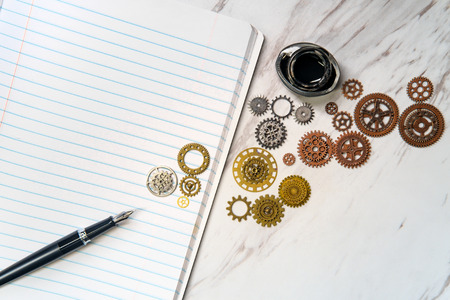 Retro pen and ink with lined notebook and gears for creative writing metaphorの写真素材